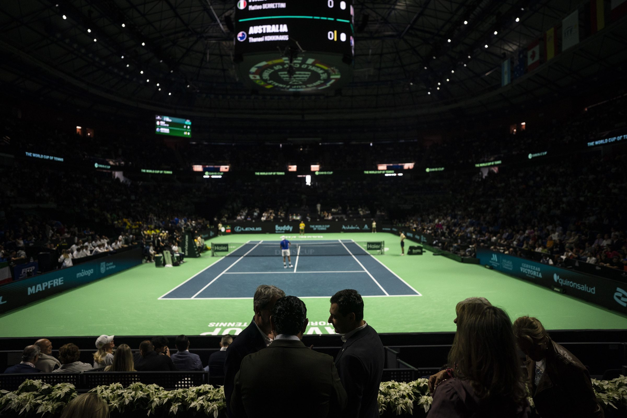 Tennis court set up at the Martín Carpena Sports Palace in Málaga during the Davis Cup finals, with spectators in the stands